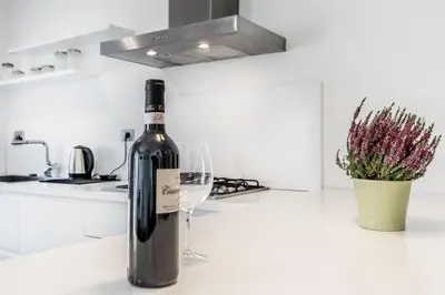 a bottle of wine sitting next to a wine glass at BBHOME Tiburtina Station apartment in Rome