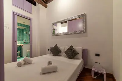 a bedroom with a bed with a mirror on the wall at GuestHost - Lovely Apartment ad un passo da Piazza del Popolo! in Rome