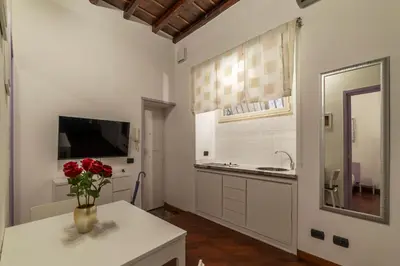 a bathroom with a sink and a vase of flowers on a table at GuestHost - Lovely Apartment ad un passo da Piazza del Popolo! in Rome