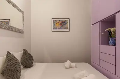 a bedroom with a bed with a purple cabinet at GuestHost - Lovely Apartment ad un passo da Piazza del Popolo! in Rome