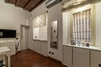 a large kitchen with white cabinets and a large window at GuestHost - Lovely Apartment ad un passo da Piazza del Popolo! in Rome