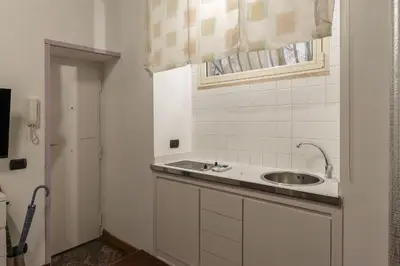 a white bathroom with a sink and a window at GuestHost - Lovely Apartment ad un passo da Piazza del Popolo! in Rome