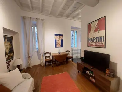 a living room with a couch and a flat screen tv at pantheon luxury apartment in Rome