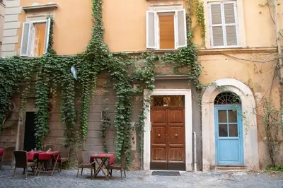 a building with ivy growing on the side of it at pantheon luxury apartment in Rome
