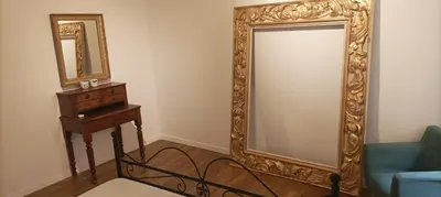 a room with a large mirror and a blue couch at pantheon luxury apartment in Rome