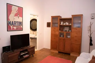 a living room with a flat screen tv and wooden cabinets at pantheon luxury apartment in Rome