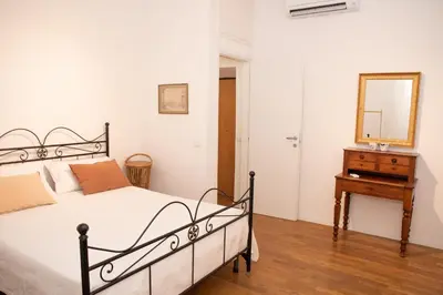 a bedroom with a bed and a mirror and a dresser at pantheon luxury apartment in Rome