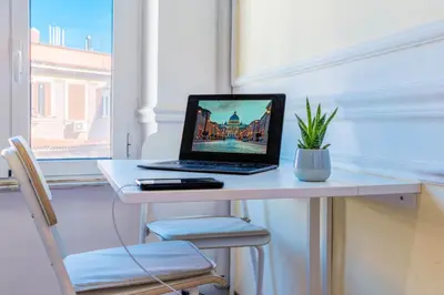 a laptop computer sitting on a desk in a room at Vatican Place in Rome