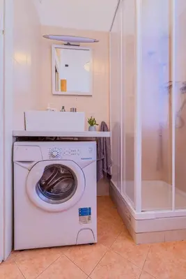 a washing machine in a bathroom with a shower at Vatican Place in Rome