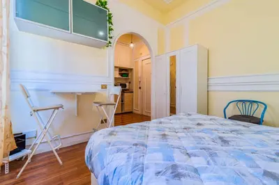 a bedroom with a bed and a table and chairs at Vatican Place in Rome