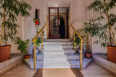 a staircase in a building with potted plants at Vatican Place in Rome