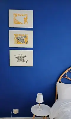 a blue bedroom with a bed and a blue wall at Casa Carbone in Rome