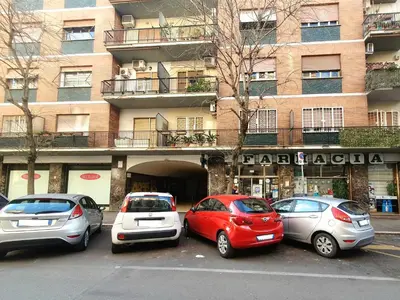 a group of cars parked in a parking lot in front of a building at Casa Carbone in Rome