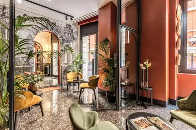 a lobby with plants and chairs in a building at Residenza Piranesi Boutique Hotel in Rome