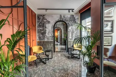 a hallway with plants and chairs in a building at Residenza Piranesi Boutique Hotel in Rome