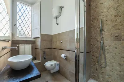 a bathroom with a shower and a toilet and a sink at GuestHost - Tra Castel Sant'Angelo e Città del Vaticano Flat in Rome