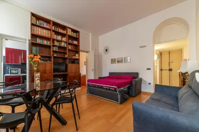 a living room with a table and a couch at GuestHost - Tra Castel Sant'Angelo e Città del Vaticano Flat in Rome