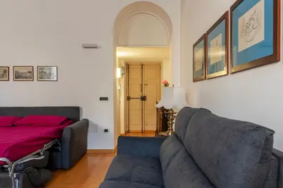 a living room with a couch and a bed at GuestHost - Tra Castel Sant'Angelo e Città del Vaticano Flat in Rome