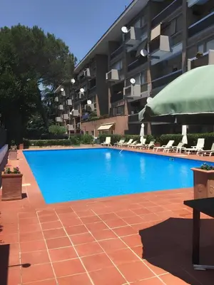 a large blue swimming pool in front of a building at Nonna Cocchina House Rome close to Vatican City in Rome