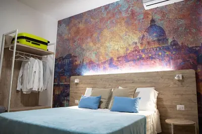a bedroom with a bed with a painting on the wall at Domus Coriolano in Rome