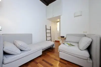 a living room with a couch and a chair at Beautiful Apartment in Campo de Fiori in Rome