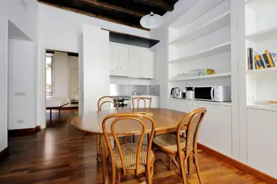 a kitchen and dining room with a table and chairs at Beautiful Apartment in Campo de Fiori in Rome