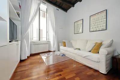 a living room with a white couch and a glass table at Beautiful Apartment in Campo de Fiori in Rome