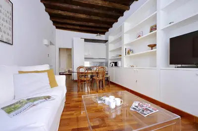 a living room with a white couch and a glass table at Beautiful Apartment in Campo de Fiori in Rome