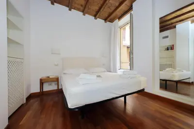 a small room with a bed and a window at Beautiful Apartment in Campo de Fiori in Rome