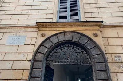 a building with a door with a sign above it at Beautiful Apartment in Campo de Fiori in Rome