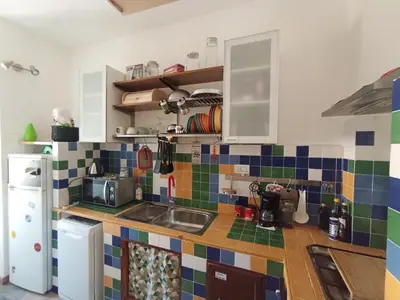 a kitchen with colorful tiles on the counter top at Casa Bambù in Rome
