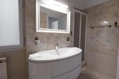a bathroom with a white sink and a mirror at The Majestic Residence in Vatican in Rome