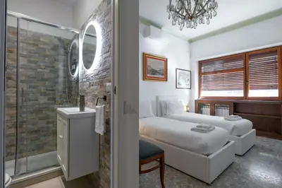 a bedroom with a bed and a glass shower at The Majestic Residence in Vatican in Rome