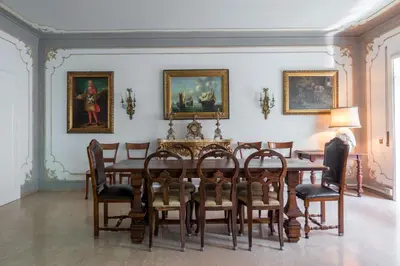 a dining room with a table and chairs at The Majestic Residence in Vatican in Rome