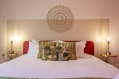 a bedroom with a white bed with two pillows at Oasis Rome Centre Apartment in Rome