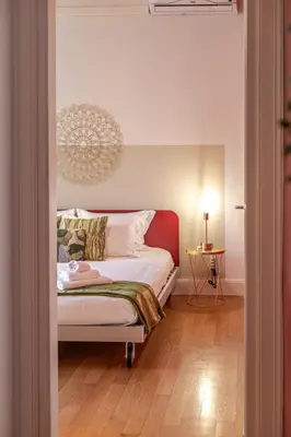 a bedroom with a bed and a table with a lamp at Oasis Rome Centre Apartment in Rome