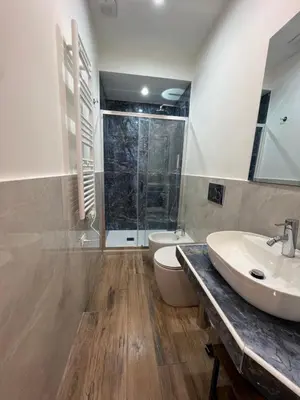 a bathroom with a sink and a toilet and a shower at Ele Suites Pantheon in Rome