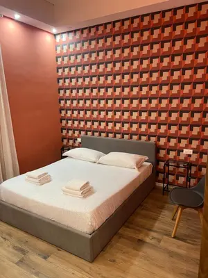 a bedroom with a bed and a brick wall at Ele Suites Pantheon in Rome