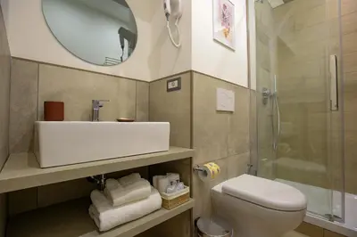 a bathroom with a toilet and a sink and a shower at Colosseum Maison in Rome