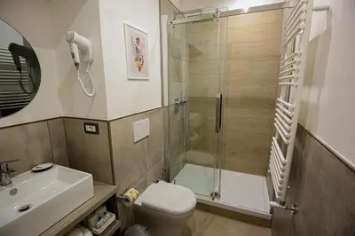 a bathroom with a shower and a toilet and a sink at Colosseum Maison in Rome