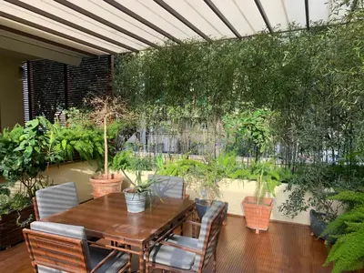 a patio with a table and chairs and plants at Appartamento con terrazza centrale e luminoso in Rome
