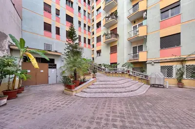 a courtyard of an apartment building with plants at Luigi's Home, Cozy Apartment Metro San Paolo in Rome