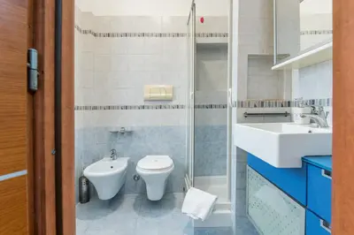 a bathroom with a toilet and a sink at Luigi's Home, Cozy Apartment Metro San Paolo in Rome