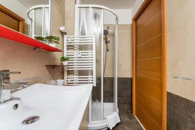 a bathroom with a white sink and a shower at Luigi's Home, Cozy Apartment Metro San Paolo in Rome