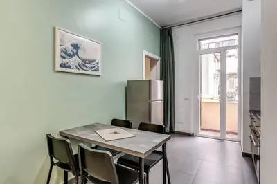 a dining room with a table and chairs and a refrigerator at New Flat Near Termini Station in Rome