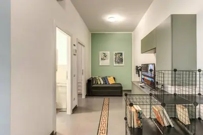 a living room with green walls and a couch at New Flat Near Termini Station in Rome