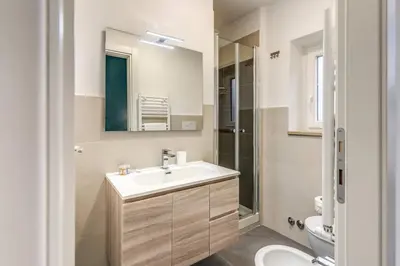 a bathroom with a sink and a toilet and a mirror at New Flat Near Termini Station in Rome