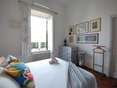a bedroom with a white bed and a window at La Dimora Torlonia Elegance & light in Rome in Rome