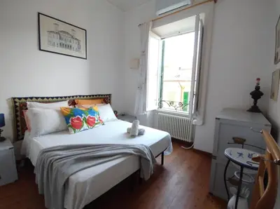a bedroom with a bed with white sheets and a window at La Dimora Torlonia Elegance & light in Rome in Rome