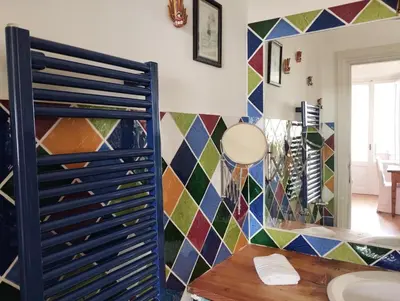 a room with a blue door and a colorful tiled wall at La Dimora Torlonia Elegance & light in Rome in Rome